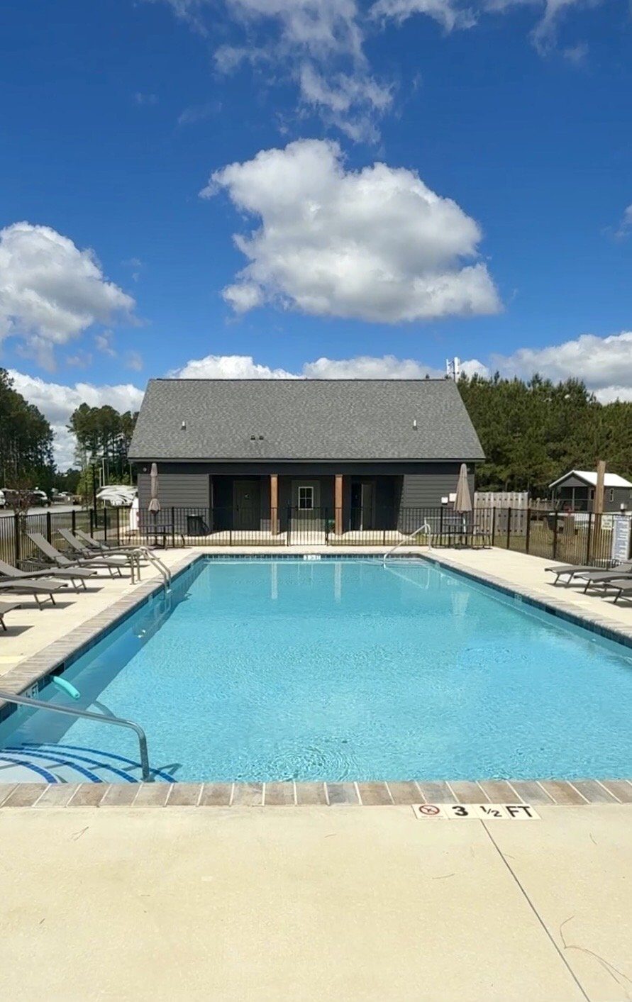 The swimming pool at In The Pines RV and Cabin Village seen from above
